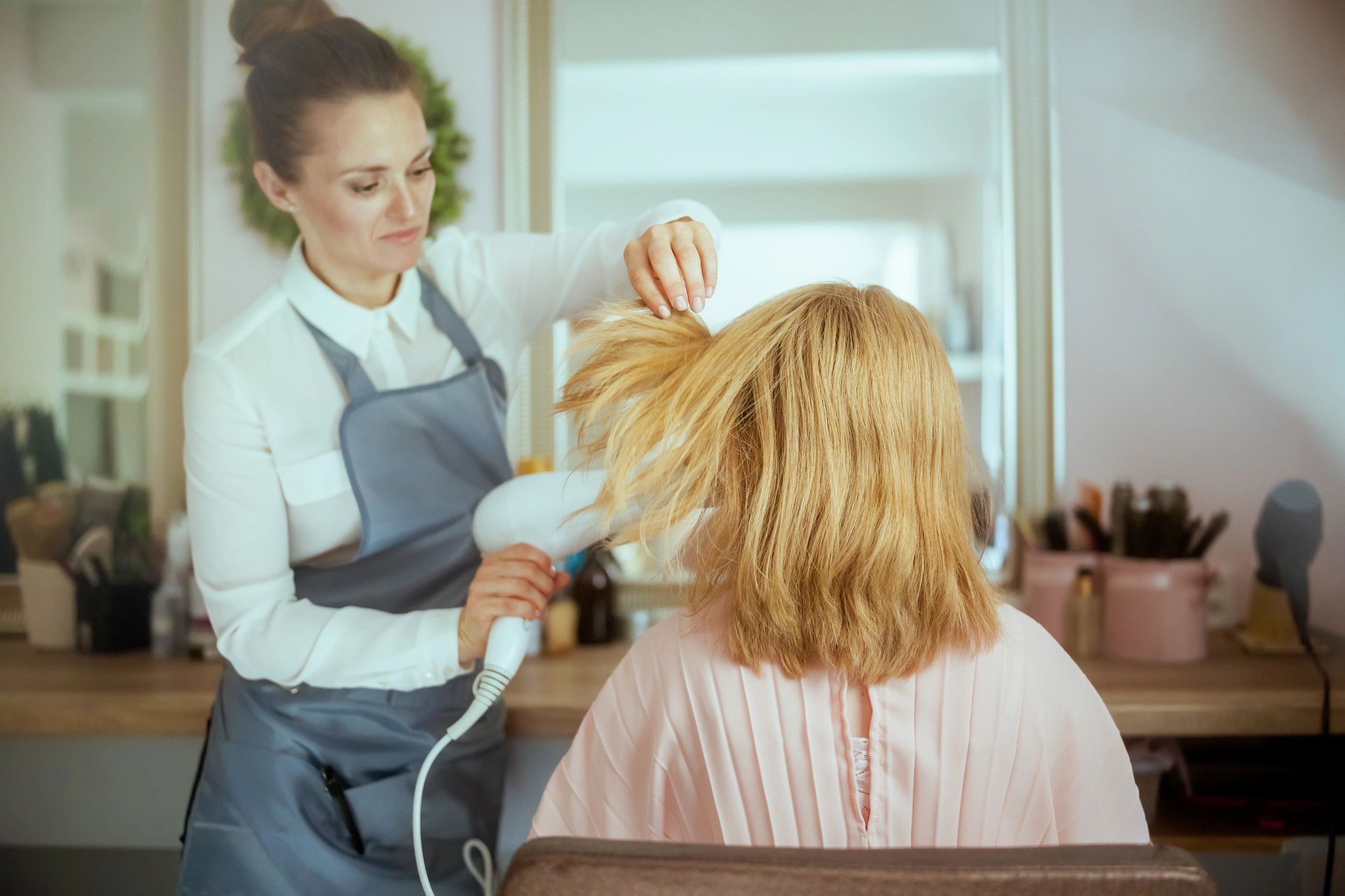 Pensive woman hair salon worker
