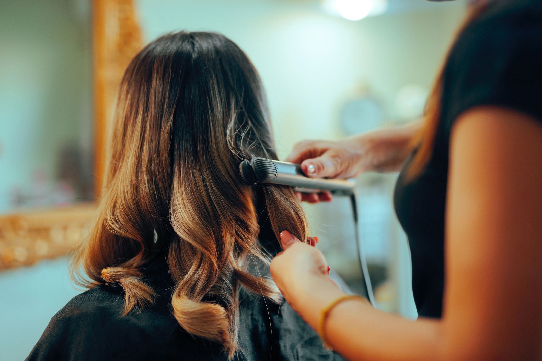 Woman having hair styled after trim