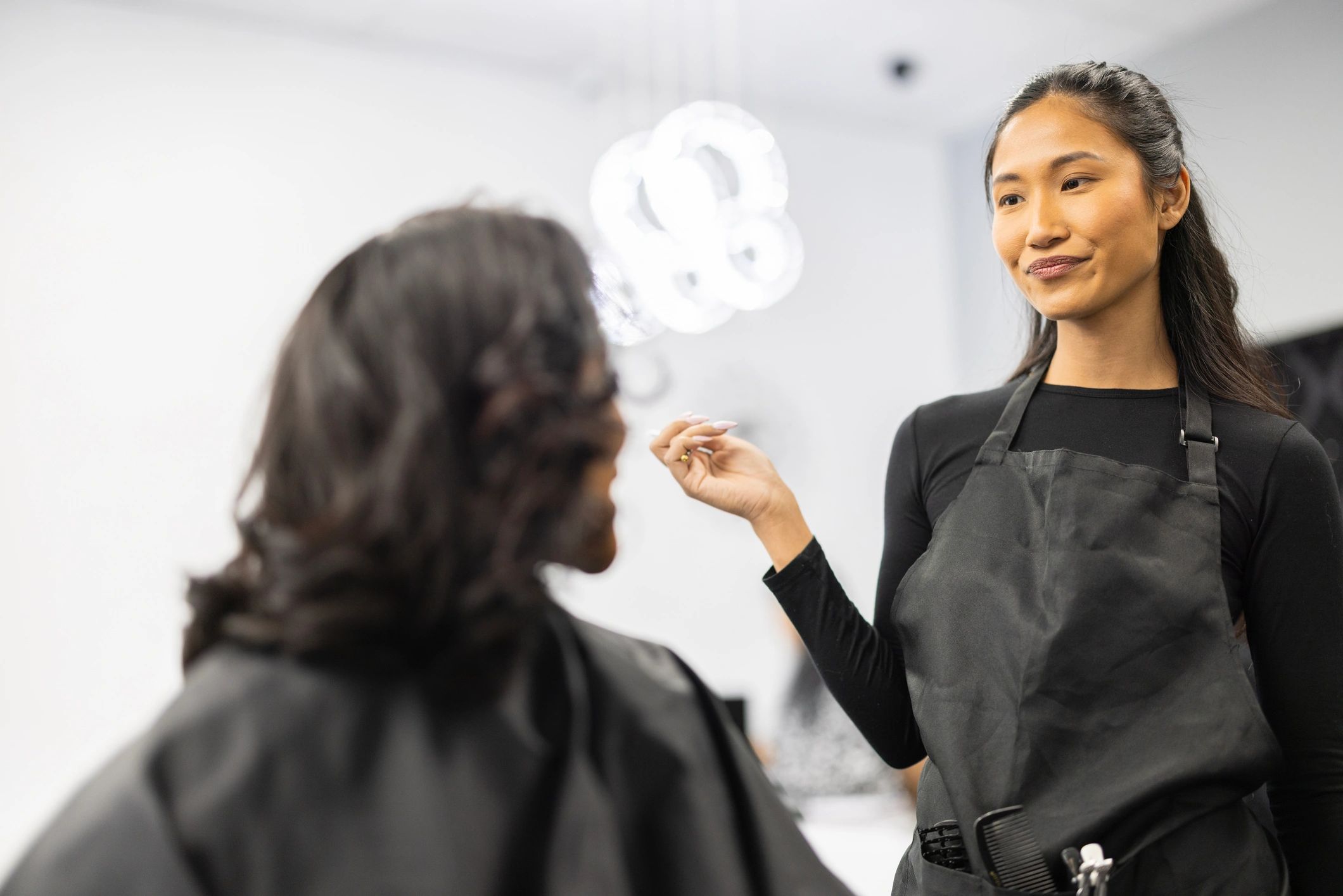 Precision haircutting tools and stylist at work